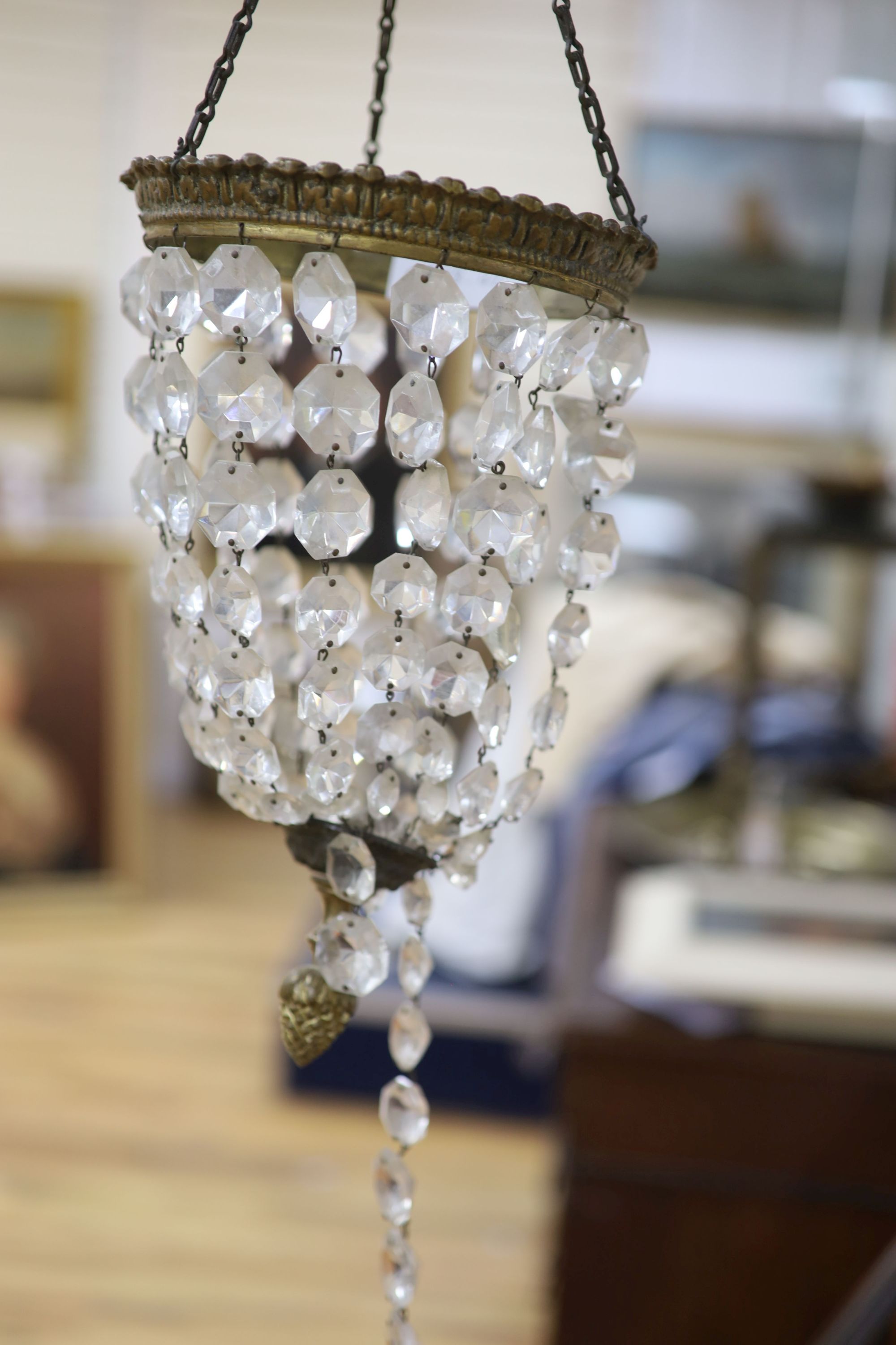 An Edwardian gilt metal and crystal drop bag chandelier and a Tiffany style lamp